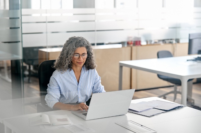 woman using laptop on desk