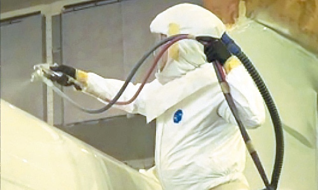 man in ppe doing coatings