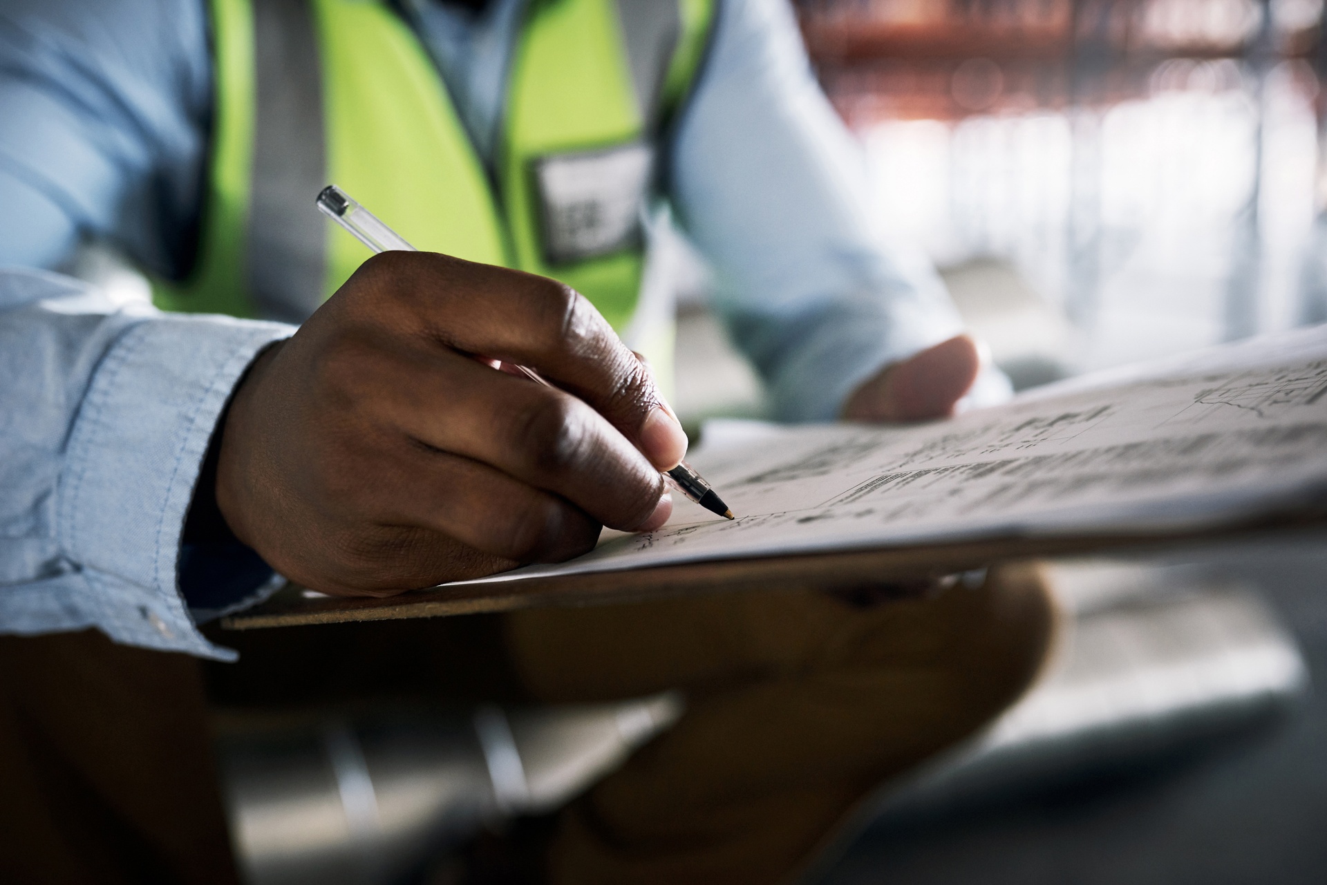 person writing on a clipboard