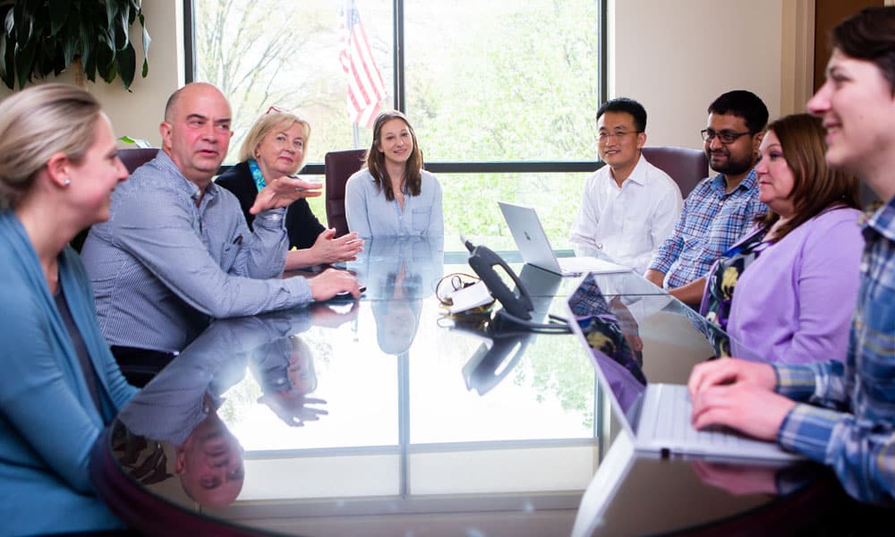 colleagues sitting at a conference room in a discussion