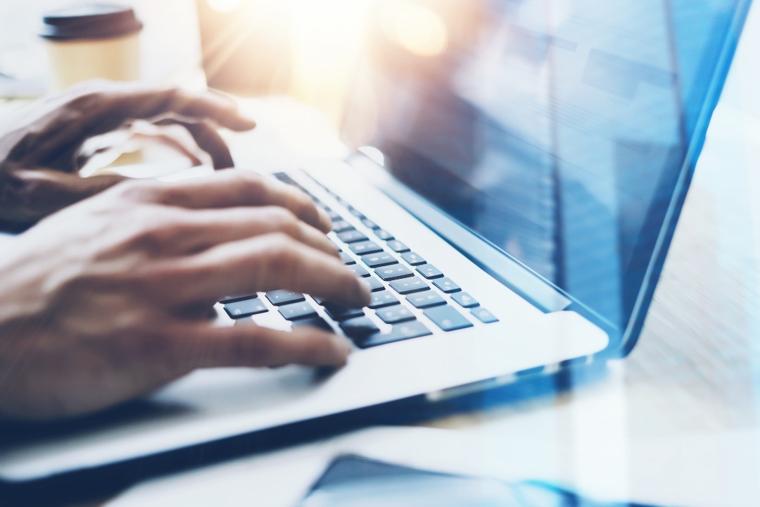 Typing on a laptop