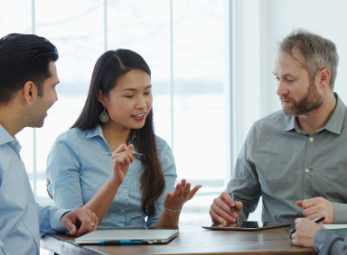 people talking in a team room